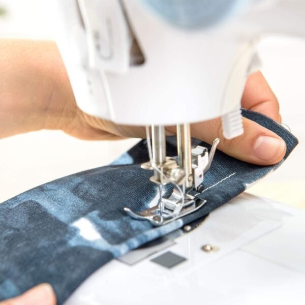 A close-up of a Solac sewing machine with various accessories and a knob for selecting stitches