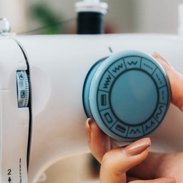 A Solac sewing machine with 12 stitches and various accessories on a white table