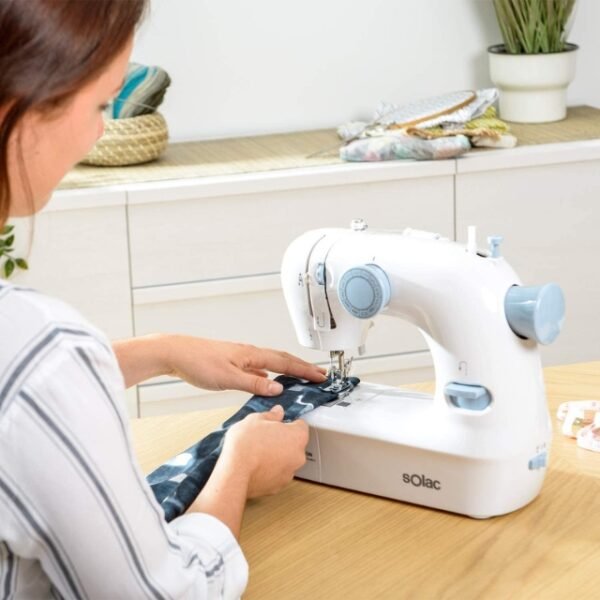 A white Solac sewing machine with various attachments and a knob for selecting stitchesA white Solac sewing machine with various attachments and a knob for selecting stitches