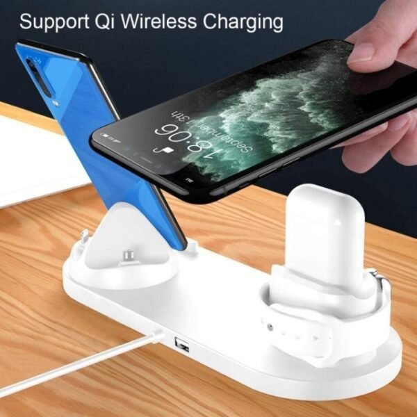 A wireless charger station holding an iPhone, an Apple Watch and AirPods on a wooden desk.