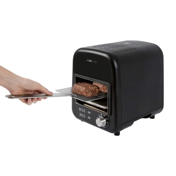 Hand holding utensil and taking beefy patties from the Clatronic cooker. Image is isolated on white background.