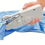 A white handheld sewing machine with an extension spindle.