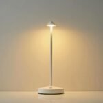 Minimalist white table lamp with long-lasting battery on a smooth surface.