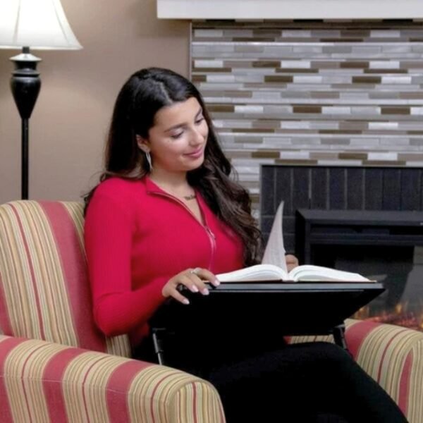 Woman on living room couch with book on Air Space table.