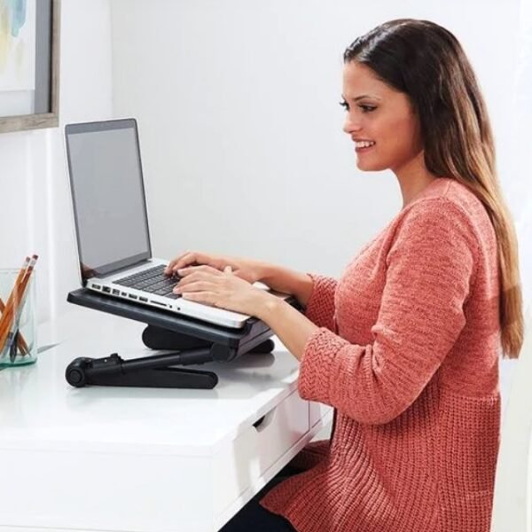 Female typing on laptop with adjustable Air Space laptop table.