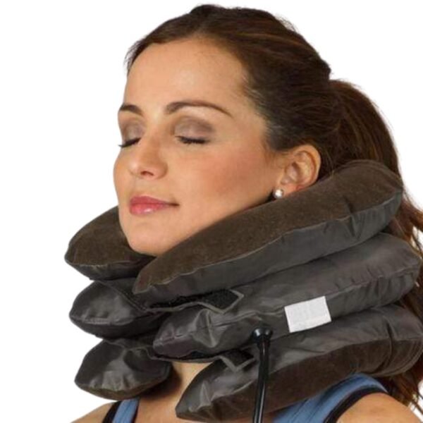 Woman with closed eyes enjoying the health benefits of the brown cervical traction pillow.