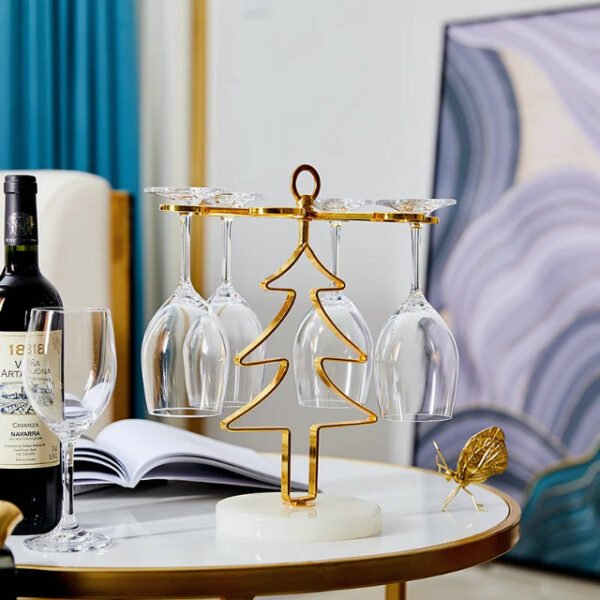 Christmas tree glass holder on table next to bottle of wine, serving drinks in style.