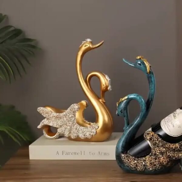 Gold and blue Couple Swan wine holders enchant on a beautiful counter.