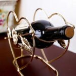 Cupid wine rack from the front, holding a wine bottle stylishly.