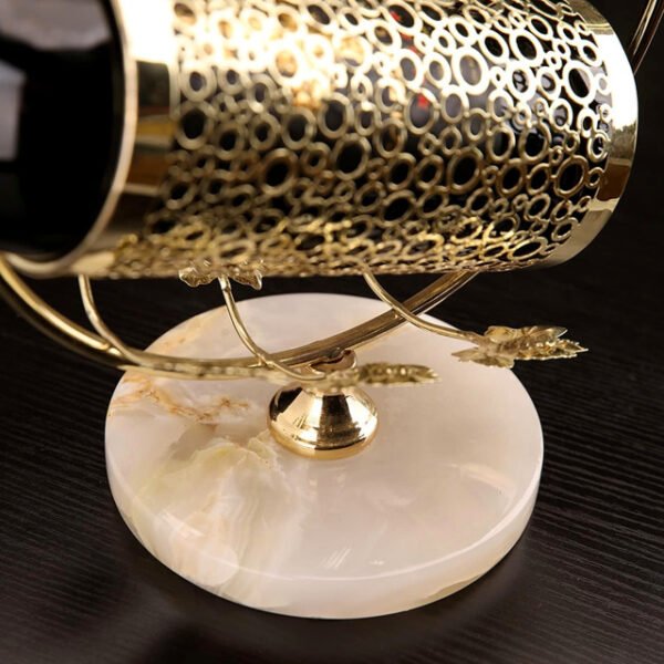 Close-up view of honeycomb bottle holder design with intricate golden details.