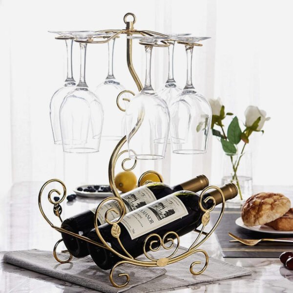 Golden vine wine rack on kitchen counter holding two bottles and six glasses in gold finish.