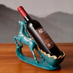 Graceful deer wine rack in blue from the side, holding a bottle at an angle.
