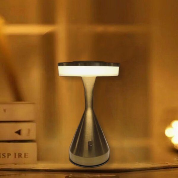 Hourglass table lamp with striking bronze finish and frosted glass shade.