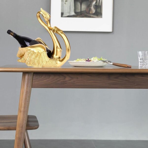 Love swans wine rack in gold on dining table enhancing meal ambiance.