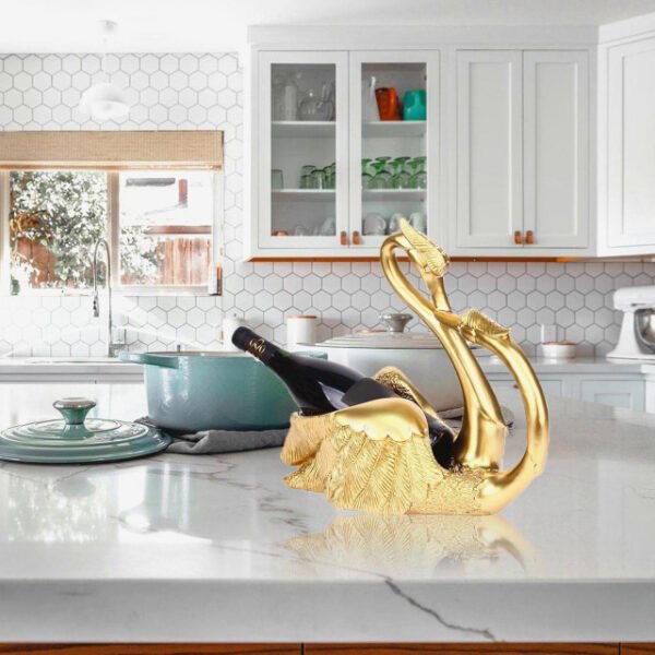 Love swans wine rack in gold on kitchen counter holding champagne.