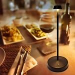 Nordic table lamp in black on a dinner table featuring a long-lasting lithium-ion battery lasting up to 9 hours.