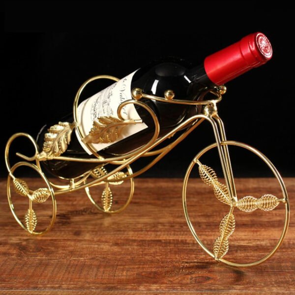 Chic gold tricycle wine rack on a brown table, highlighting shiny finish.