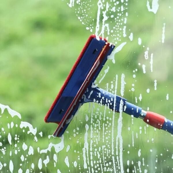 2-in-1 glass cleaner in action, washing away soap from a window.