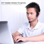 Professional using AY-101 Wireless Microphone for online meeting with clear sound.