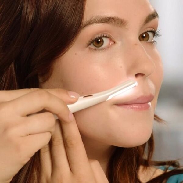 Woman using Flawless Dermaplane Glow to exfoliate and trim her moustache area for a radiant complexion.