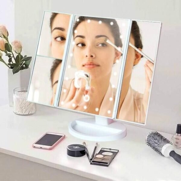 Superstar makeup magnifying mirror on bedroom table with woman's reflection and LED lights.