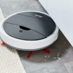Vileda VR-One Robot Cleaner effortlessly handling crumbs under a cabinet.