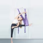 Woman flexing legs with Aerial Yoga Resistance Rope.