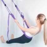 Woman stretching lower back with Yoga Resistance Rope.