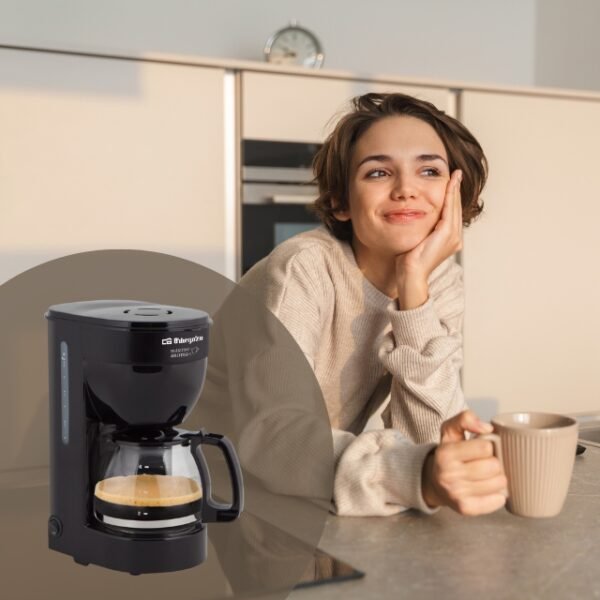 Woman savoring her morning coffee made by the Orbegozo Coffee Maker.