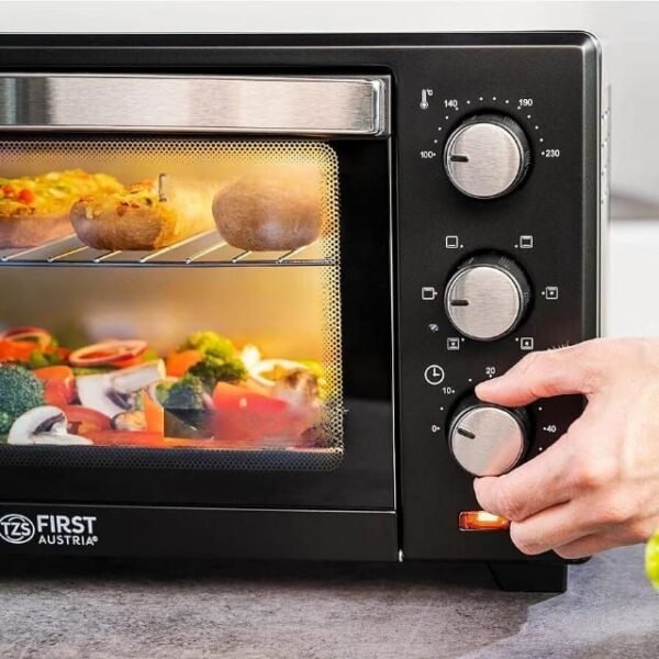 Man adjusting timer on First Austria electric oven.