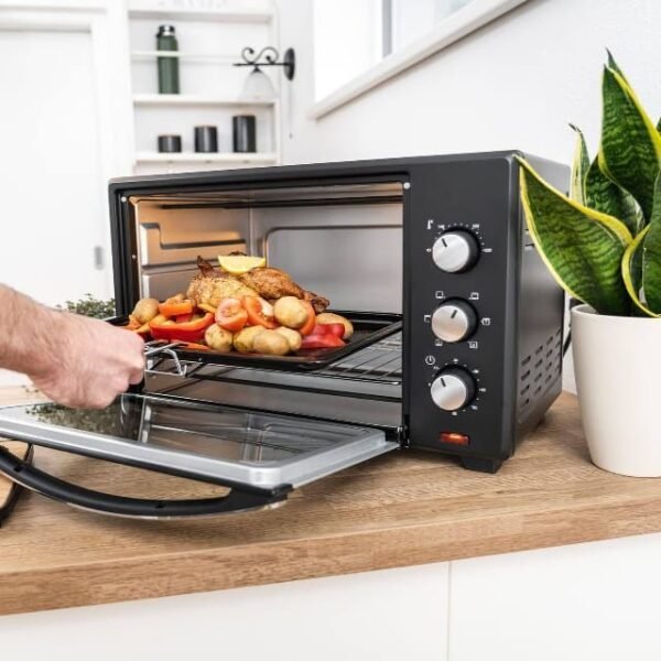 Man using First Austria electric oven for dinner.