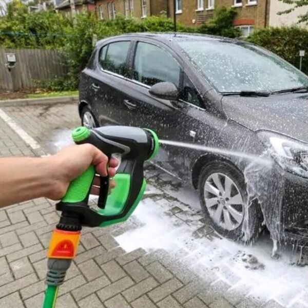 Foam spray gun vertically dispensing water for post-soap car rinse.