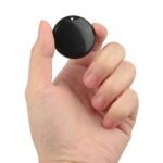 Hand holding discreet GPS tag—compact and effective.