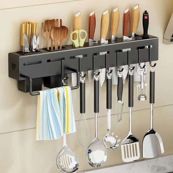 Kitchen utensil storage rack in stylish black above a sink, holding spoons, forks, and knives with a convenient towel hanger.