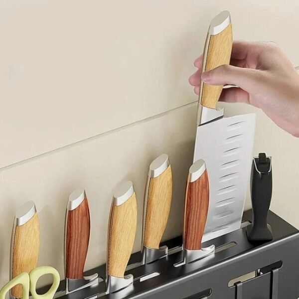 Woman using the kitchen utensil storage rack to pull out a knife—practical and convenient storage for up to 8 knives.