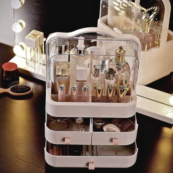 Pink makeup storage box on bedroom counter, showcasing serums, jewelry, lotions, and makeup.