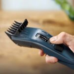 Man Holds Philips 3000 Series Trimmer, Adjusting Length with Modern Design – Effortless Grooming.