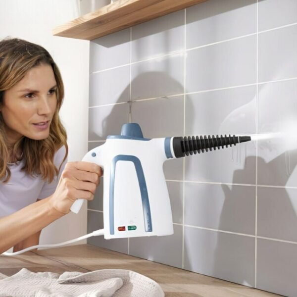 Woman using Switch-On steam cleaner on kitchen walls with latest technology.