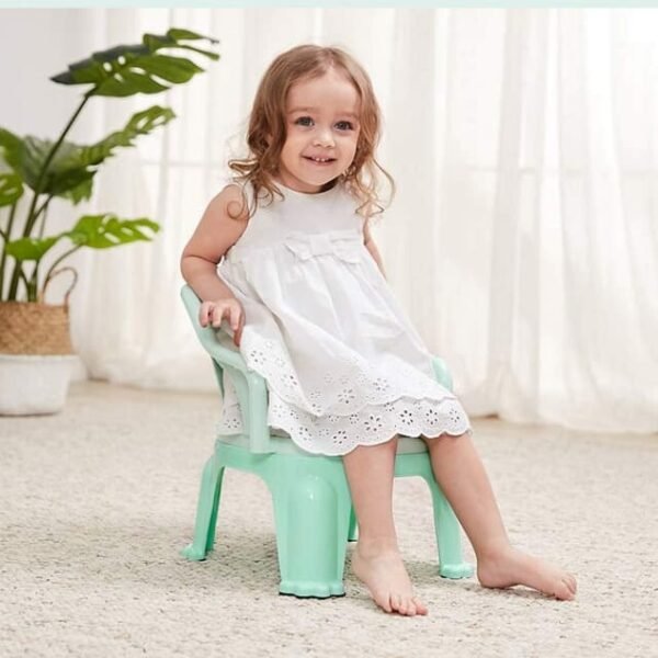 Happy baby girl on a sturdy pink baby high chair.