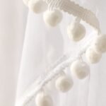 Safe beyond borders: Cotton ball design on mosquito net.