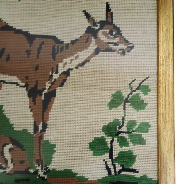 Close-up of deer art in brown frame.