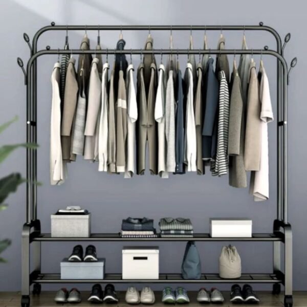 Bedroom setting with organized garments on black double steel cloth rack.