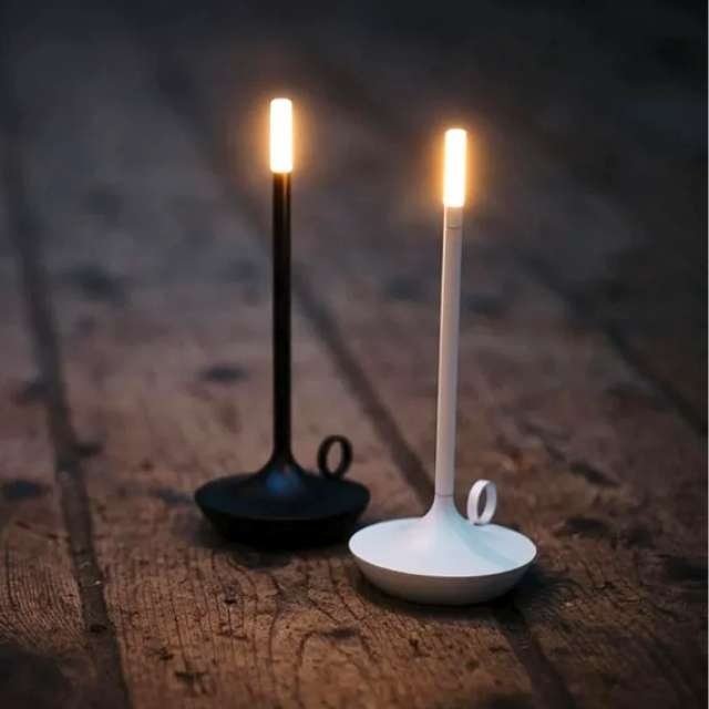 Aladdin table lamps in white and black on wooden floor board.