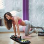 Woman using digital push up board for full-body workout.