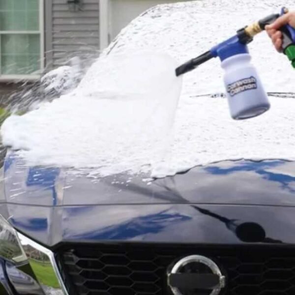 Car wash cannon splashing car clean with water and foam.