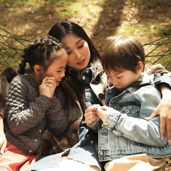 Outdoor net hammock with mother and kids.