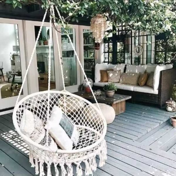 Swing hammock chair on patio for stylish outdoor relaxation.