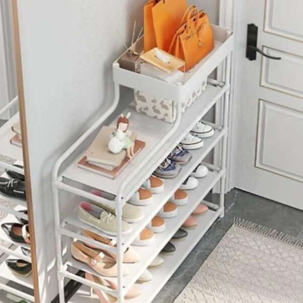 Side view of white shoe rack organizer in bedroom holding accessories.