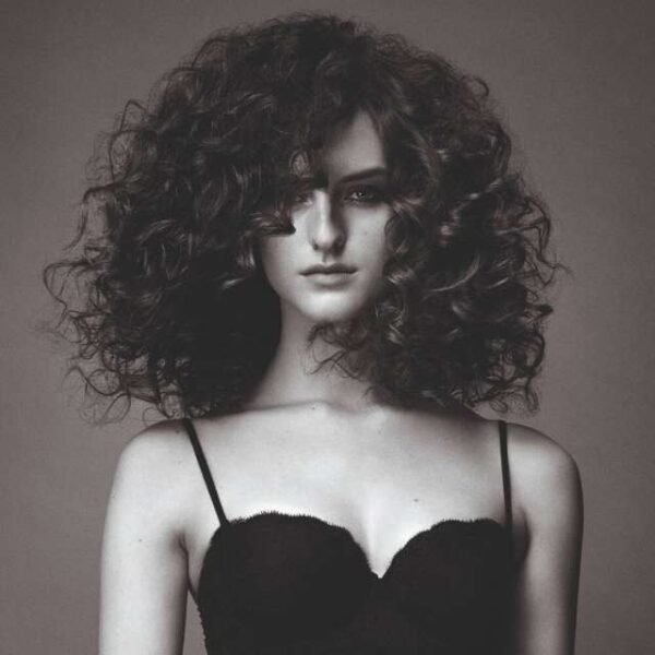 Woman with beautiful curls after using the Babyliss hair curler.