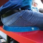 Man seated on bench with egg sitter seat cushion.